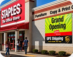 Staples storefront with grand opening signage
