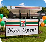 7-Eleven Now Open roadside sign