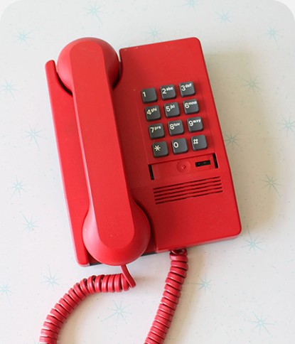 Red telephone handset on a hook